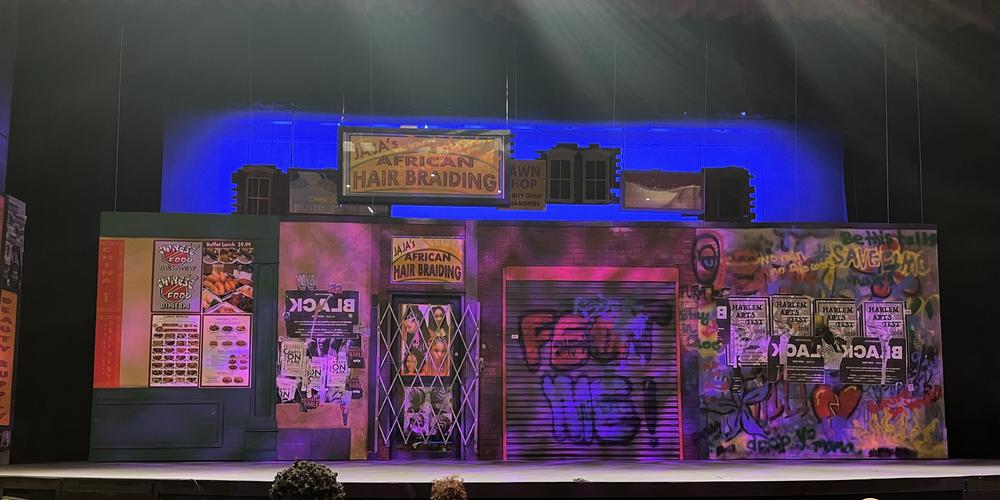 The set for the play recreates a New York City street and several storefronts.